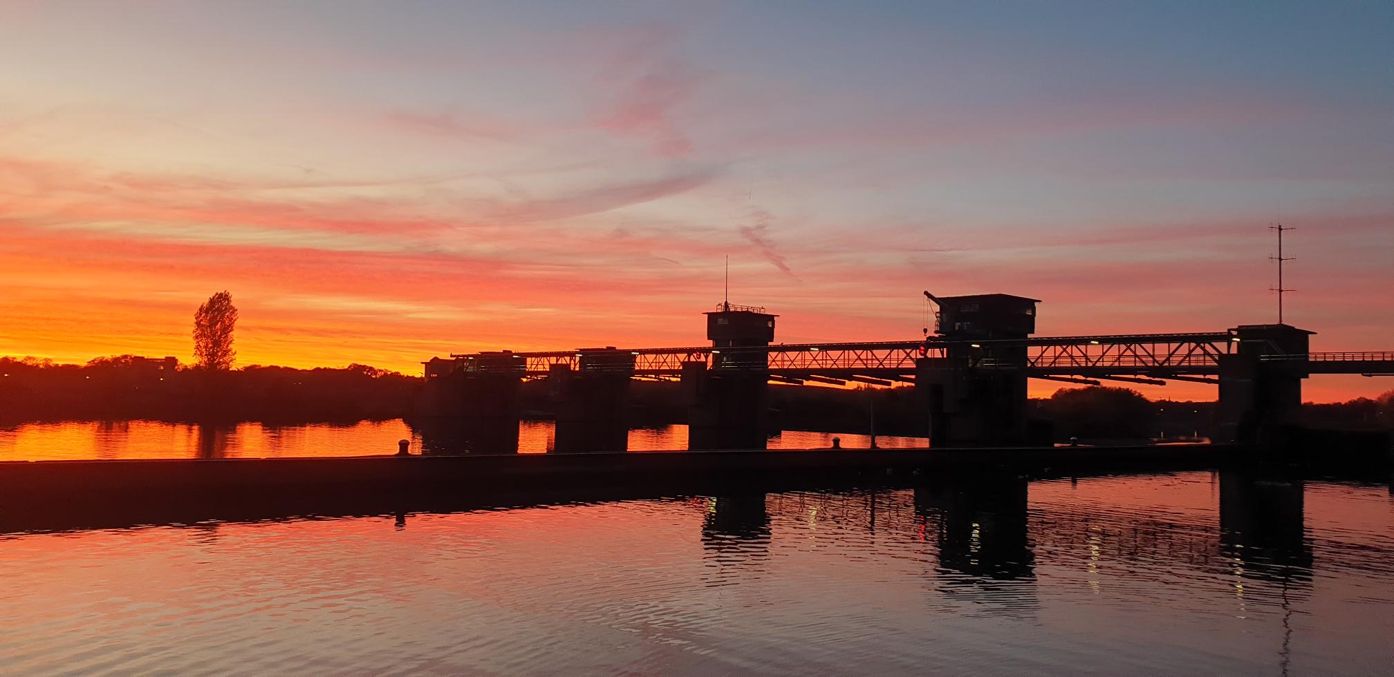 De sluis in de Maas bij zonsondergang
